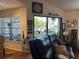 Living room with large windows, hardwood floors, and comfortable seating at 506 Lennox W Rd # 506, Palm Harbor, FL 34683