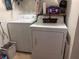 Functional laundry room with a washer and dryer, plus shelving for storage and organization at 506 Lennox W Rd, Palm Harbor, FL 34683