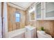 Updated bathroom with a bathtub, sink, and toilet, featuring modern tile and fixtures at 5310 10Th N St, St Petersburg, FL 33703