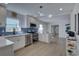 Modern kitchen with white cabinets, blue tile backsplash, and island at 5310 10Th N St, St Petersburg, FL 33703