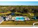 Aerial view showing community pool, playground, and lush landscape at 6609 114Th E Ave, Parrish, FL 34219