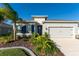 Single-story house with gray exterior, two-car garage, and attractive landscaping at 6609 114Th E Ave, Parrish, FL 34219