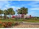 Community entrance sign with landscaping and palm trees at 6807 King Creek Dr, Sun City Center, FL 33573