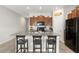 Modern kitchen with wood cabinets, granite counters and island at 6807 King Creek Dr, Sun City Center, FL 33573