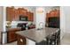 Modern kitchen with wood cabinets, granite counters and island at 6807 King Creek Dr, Sun City Center, FL 33573