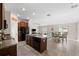 Open kitchen with island, wood cabinets and view of dining area at 6807 King Creek Dr, Sun City Center, FL 33573