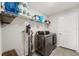 Laundry room with washer, dryer, and shelving at 6807 King Creek Dr, Sun City Center, FL 33573