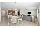 Open concept living room and kitchen, gray sofa and tile floors at 6807 King Creek Dr, Sun City Center, FL 33573