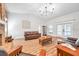 Open living room showcasing hardwood floors and a brick fireplace at 9502 59Th E Ave, Bradenton, FL 34202