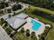 Community pool and clubhouse with lush green surroundings at 1212 Bayou Pass Dr, Ruskin, FL 33570