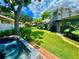 Backyard view showing hot tub, lawn, and shed at 1003 Beverly Ave, Largo, FL 33770