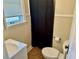 Simple bathroom with a shower, toilet, and pedestal sink at 1003 Beverly Ave, Largo, FL 33770