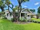 Charming single-Gathering home showcasing a welcoming front porch and lush landscaping at 1003 Beverly Ave, Largo, FL 33770