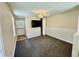 Living room with grey carpet, ceiling fan, and built-in shelving at 1003 Beverly Ave, Largo, FL 33770