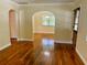 Bright living room with hardwood floors and an archway leading to the dining area at 1003 Beverly Ave, Largo, FL 33770