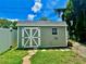 Gray storage shed with white trim and double doors at 1003 Beverly Ave, Largo, FL 33770