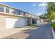 Row of townhouses with attached garages and a driveway at 10068 Old Haven Way, Tampa, FL 33624