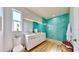 Modern bathroom with a floating vanity, turquoise tile shower, and natural light at 10101 Eagle Preserve Dr, Englewood, FL 34224