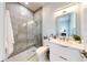 Modern bathroom with gray tile, glass shower, and a white vanity with marble countertop at 10101 Eagle Preserve Dr, Englewood, FL 34224
