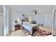 Well-lit bedroom with a zebra print rug, ceiling fan, and a modern dark wood bed frame at 10101 Eagle Preserve Dr, Englewood, FL 34224