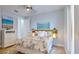 Cozy bedroom with beach artwork, a ceiling fan, and leaf-patterned bedding at 10101 Eagle Preserve Dr, Englewood, FL 34224