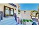 Inviting front entrance with modern black door and sleek black railings up to the house at 10101 Eagle Preserve Dr, Englewood, FL 34224