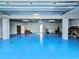 Spacious garage featuring high ceilings, ample lighting and an epoxy coated floor at 10101 Eagle Preserve Dr, Englewood, FL 34224
