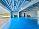 Spacious garage with an open door, an epoxy floor, and a glimpse of the neighborhood at 10101 Eagle Preserve Dr, Englewood, FL 34224