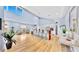 Bright and spacious kitchen and living area with high ceilings, wood floors, and modern decor create an inviting atmosphere at 10101 Eagle Preserve Dr, Englewood, FL 34224