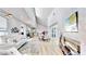 Open concept home with a modern fireplace, wood floors, bright light and view to the dining area at 10101 Eagle Preserve Dr, Englewood, FL 34224