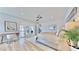 Bright main bedroom with a desk, balcony access, ceiling fan, and serene decor at 10101 Eagle Preserve Dr, Englewood, FL 34224