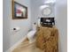 Unique powder room featuring custom vanity with granite top, modern light fixture, and tile floor at 10101 Eagle Preserve Dr, Englewood, FL 34224