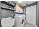 Laundry room with washer, dryer, and additional shelving at 1040 Kent Ln, Palm Harbor, FL 34683