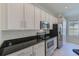 Kitchen features stainless steel appliances and white cabinets at 10637 Ashford Oaks Dr, Tampa, FL 33625