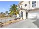 Two story house exterior with palm tree and driveway at 11275 3Rd E St, Treasure Island, FL 33706