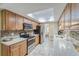 Bright kitchen with granite countertops, modern appliances, and wood cabinets at 1806 Wedge Ct, Sun City Center, FL 33573