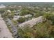 Aerial view of apartment buildings, parking lots, and a community swimming pool at 3038 Eastland Blvd # F205, Clearwater, FL 33761