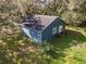 Blue house with a deck and large backyard, surrounded by trees at 3106 E Trapnell Rd, Plant City, FL 33566