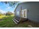 Home's back exterior with deck and access to a large backyard at 3106 E Trapnell Rd, Plant City, FL 33566