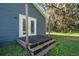 Exterior view of back of house with deck and surrounding trees at 3106 E Trapnell Rd, Plant City, FL 33566