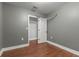 Small bedroom with hardwood floors and gray walls at 3106 E Trapnell Rd, Plant City, FL 33566