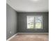 Simple bedroom with neutral walls, carpeting, and a window at 3106 E Trapnell Rd, Plant City, FL 33566