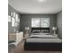 Modern bedroom with a dark gray wall and a neutral-toned bed at 3106 E Trapnell Rd, Plant City, FL 33566