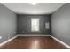 Empty bedroom with gray walls and hardwood floors at 3106 E Trapnell Rd, Plant City, FL 33566
