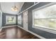 Simple dining room with gray walls, hardwood floors, and white door at 3106 E Trapnell Rd, Plant City, FL 33566