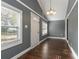 Simple dining room with gray walls, hardwood floors, and white door at 3106 E Trapnell Rd, Plant City, FL 33566