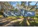 Rear view of a renovated blue house at 3106 E Trapnell Rd, Plant City, FL 33566