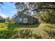 Gray house exterior with deck and lush landscaping at 3106 E Trapnell Rd, Plant City, FL 33566
