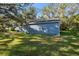 Side view of a blue house and yard at 3106 E Trapnell Rd, Plant City, FL 33566