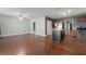 Open kitchen with island, stainless steel appliances, and wood-look flooring at 3106 E Trapnell Rd, Plant City, FL 33566